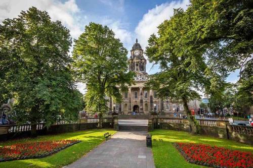 a building with a clock tower in the middle of a park at Central Morecambe, minimalist seaside flat N.1 in Morecambe