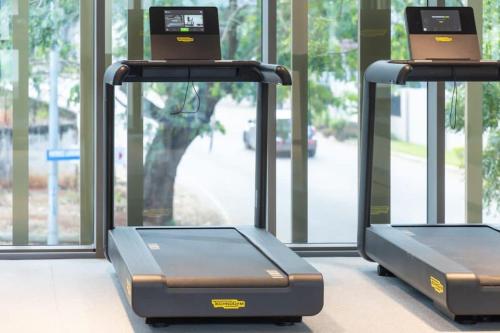 two elliptical machines in front of a window at The Lennox Studio @Airport Residential in Accra