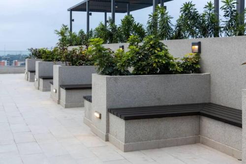 a row of benches with plants on a building at The Lennox Studio @Airport Residential in Accra