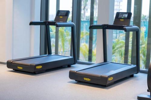 two treadmill machines sitting in a room with a window at The Lennox Studio @Airport Residential in Accra