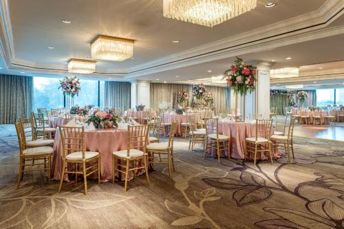 a banquet hall with tables and chairs with flowers at Intercontinental Miramar Panama by IHG in Panama City