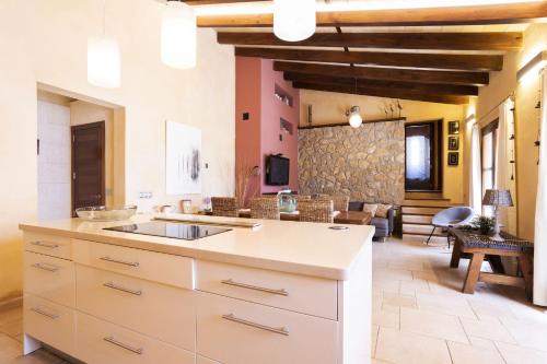 a kitchen with a sink and a living room at Villa Son 3 in Mancor del Valle
