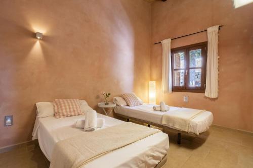 two beds in a room with a window at Villa Son 3 in Mancor del Valle