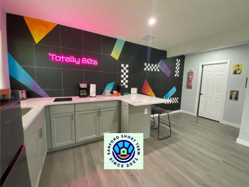 a kitchen with a counter with a sign on the wall at Totally 80s! in Sanford