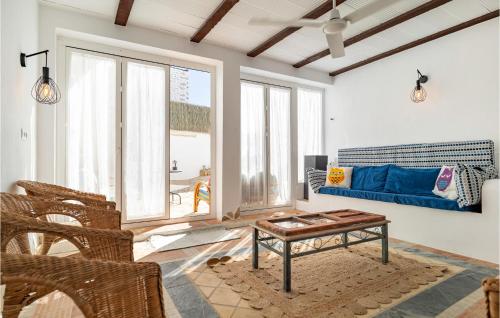 a living room with a blue couch and a table at 5 Bedroom Nice Home In Villanueva De Algaidas in Villanueva de Algaidas