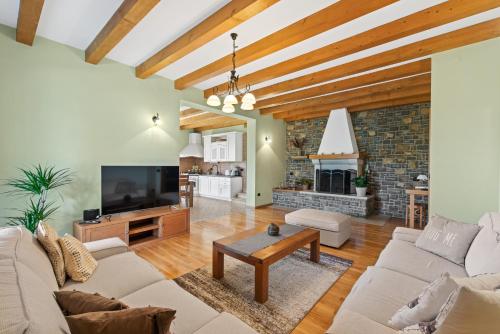 a living room with a couch and a tv at Villa Dol an ideal spa and wellness escape in Istria in Buzet