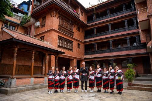 a group of people standing in front of a building at Nag Pukhu Guest House in Bhaktapur