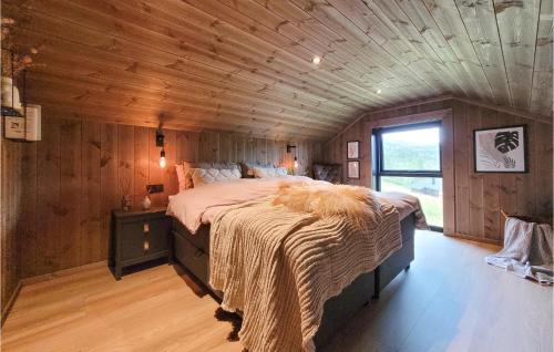 a bedroom with a large bed in a wooden ceiling at Amazing Home In Norheimsund With Wifi in Norheimsund