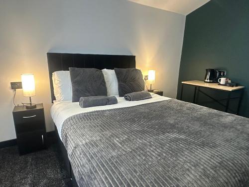 a bedroom with a large bed with two pillows on it at OYO The Avenue in Scunthorpe