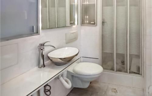 a bathroom with a toilet and a sink and a shower at Lovely Apartment In Gdynia With Wi-fi in Gdynia