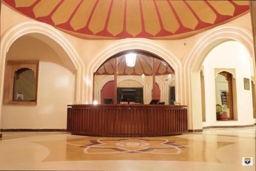 a courtroom in a building with a red and yellow awning at Hotel Deoki Niwas Palace in Jaisalmer