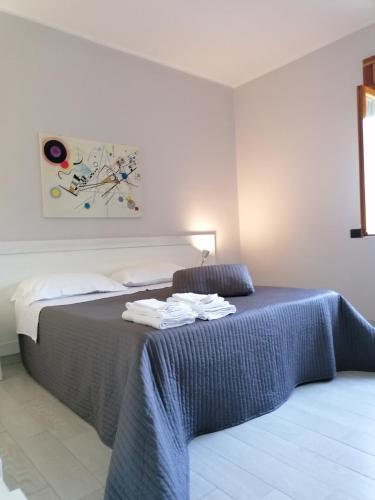 a bedroom with a bed with towels on it at Residenza Guglielmi in Campobasso