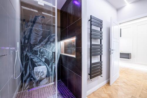 y baño con ducha de azulejos morados. en Beccaria - Florence luxury Apartment, en Florencia