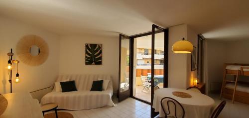 un salon avec un lit, une table et des chaises dans l'établissement Frejus Plage LA MIOUGRANO, T2-3 49m2, 5 personn, à Fréjus