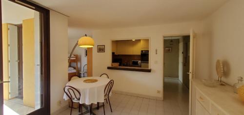 une cuisine et une salle à manger avec une table et des chaises dans l'établissement Frejus Plage LA MIOUGRANO, T2-3 49m2, 5 personn, à Fréjus