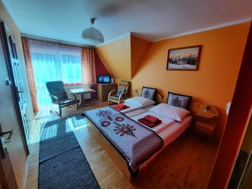 a bedroom with a bed and a desk in a room at Willa Marta M Sauna Jacuzzi in Zakopane