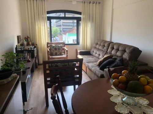 Et opholdsområde på Espaço acolhedor, no Guarujá