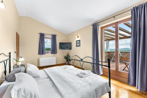 a bedroom with a bed and a large window at Villa Dol an ideal spa and wellness escape in Istria in Buzet