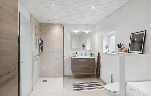 Beautiful Home In Frederikshavn With Kitchen في فريكشهاون: حمام ابيض مع مرحاض ومغسلة