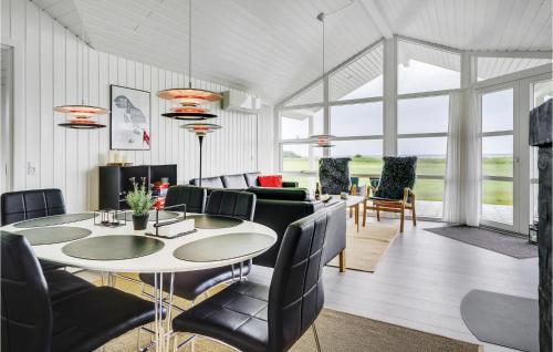 a living room with a table and chairs at Three-Bedroom Holiday Home In Nordborg in Nordborg