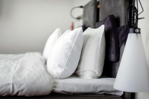 a pile of pillows sitting on a bed at Best Western Plus Sthlm Bromma in Stockholm