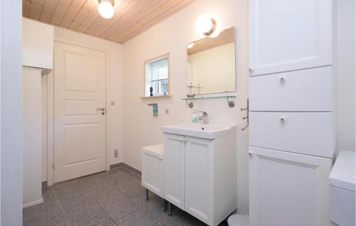 a white bathroom with a sink and a mirror at Beautiful Home In Hadsund With 3 Bedrooms And Wifi in Helberskov