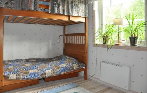 a bedroom with a bunk bed and a window at Nice Home In Gunnarskog With Lake View in Gunnarskog