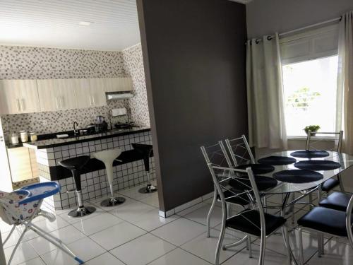 eine Küche mit einem Tisch und Stühlen im Zimmer in der Unterkunft Pousada Tia Míria 