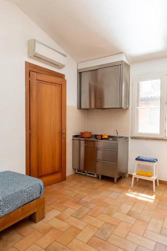 a kitchen with a stove and a sink in a room at Gitavillage Talamone in Talamone