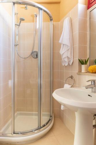 a bathroom with a shower and a sink at Gitavillage Talamone in Talamone