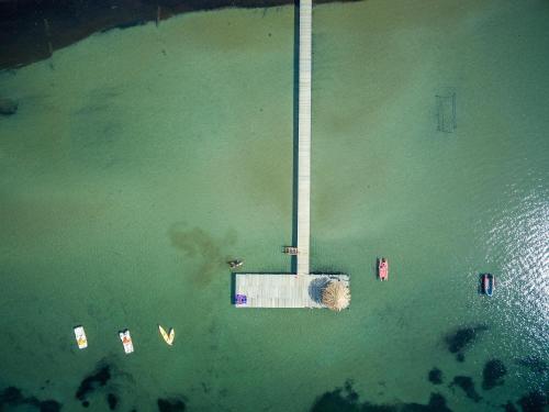 an aerial view of a body of water with a dock at Gitavillage Talamone in Talamone
