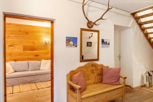 a room with a wooden bench and a couch at Villa Maria Tirol in Anras
