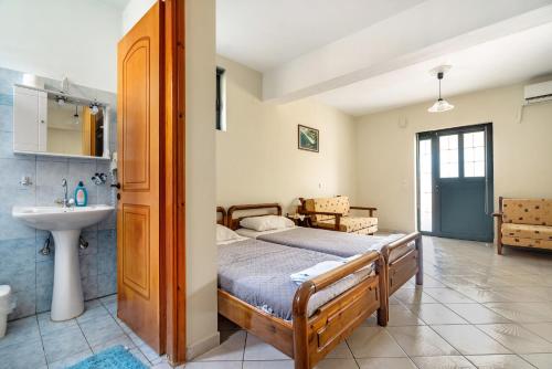 a bedroom with a bed and a sink at Daratos apartment 6 in Kefallonia