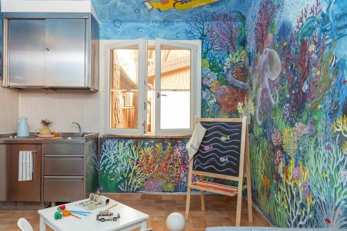 a kitchen with a painting on the wall at Gitavillage Il Gabbiano in Albinia