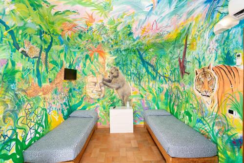 a room with a mural of tigers and plants at Gitavillage Il Gabbiano in Albinia