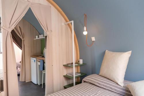 a bedroom with a bed with a canopy in a room at Gitavillage Il Gabbiano in Albinia