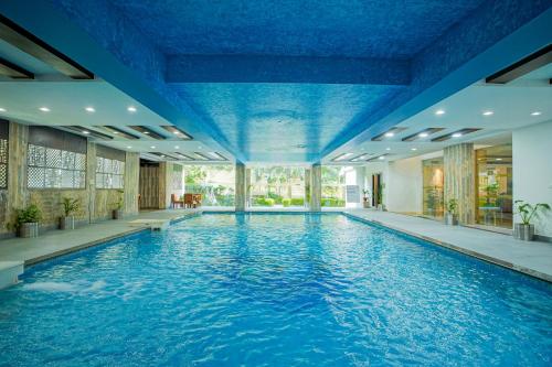 a large swimming pool with a blue ceiling at The Grand Shiva Resort and Spa in Rishīkesh