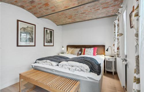 a bedroom with a bed with a wooden ceiling at Amazing Apartment In Ringkbing With Wifi in Ringkøbing