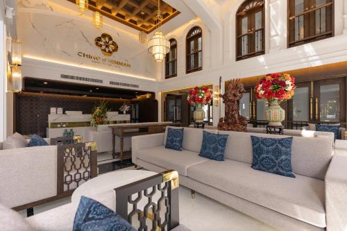 a lobby with couches and a bar in a building at CHINO@NIMMAN Luxury Boutique Hotel in Chiang Mai