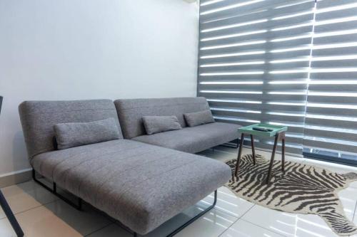 a couch sitting in a living room with a zebra at Cosy 1 Bed Loft @Embassy Gardens in Cantonments