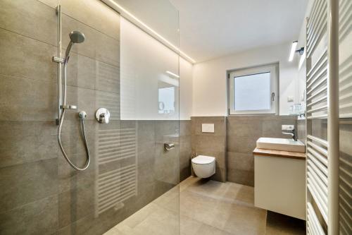 a bathroom with a shower and a toilet and a sink at Ferienwohnung Lamm 3 in San Valentino alla Muta