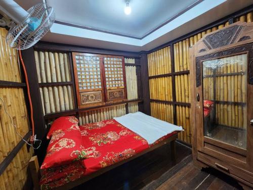 a small room with a red bed and a window at Josephine's Villa - Bangar, LU (up to 15 guests) in Bangar
