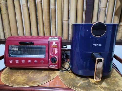 a microwave and a toaster sitting on top of a table at Josephine's Villa - Bangar, LU (up to 15 guests) in Bangar