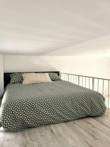 een bed met een zwart-wit dekbed in een slaapkamer bij Guest House (15 min metro dal Duomo) in Milaan