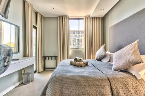 a bedroom with a bed with two pumpkins on it at Chelsea on Main in Cape Town