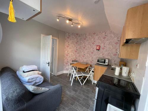 a living room with a couch and a kitchen at Parnell Place Apartments in Dublin