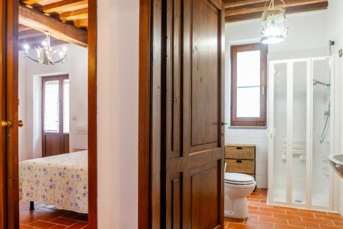 a bathroom with a toilet and a sink in a room at Bruco in Montiano