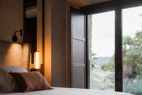 a bedroom with a bed and a window with a view at Castilla Termal Brihuega in Brihuega