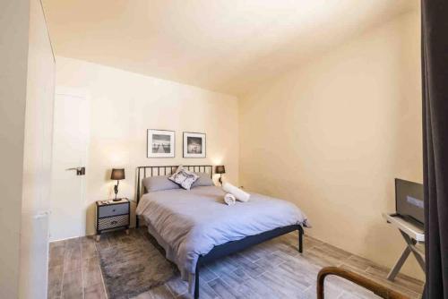 a bedroom with a bed and a television in it at Kalkara 4 in Cospicua
