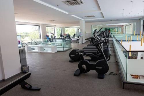 a gym with treadmills and ellipticals in a room at Cosy 1 Bedroom @Embassy Gardens in Cantonments